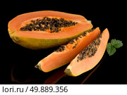 Fresh and tasty papaya on black background. Стоковое фото, агентство Ingram Publishing / Фотобанк Лори