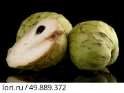 Custard apple, also known as Bullocks or Bulls Heart.On black with reflection. Стоковое фото, агентство Ingram Publishing / Фотобанк Лори