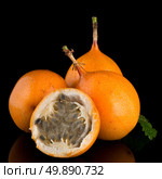 Passion fruit maracuja granadilla on black background. Стоковое фото, агентство Ingram Publishing / Фотобанк Лори
