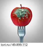 Rotten food symbol and spoiled awful meal concept as a fork holding a spoiled apple with fungus growing with 3D illustration elements as a metaphor for meals that are not fresh. Стоковое фото, агентство Ingram Publishing / Фотобанк Лори