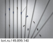 Ruthless business concept and brutal competitive strategy idea as a group of businesspeople climbing ladders with one severe person pushing down competitors eliminating competition with 3D illustration elements. Стоковое фото, агентство Ingram Publishing / Фотобанк Лори