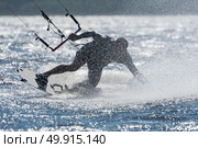 Kiteboarder enjoy surfing on a sunny day. Стоковое фото, агентство Ingram Publishing / Фотобанк Лори
