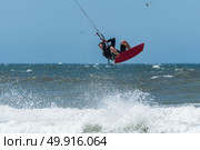 Kiteboarder enjoy surfing on a sunny day. Стоковое фото, агентство Ingram Publishing / Фотобанк Лори