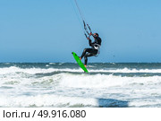 Kiteboarder enjoy surfing on a sunny day. Стоковое фото, агентство Ingram Publishing / Фотобанк Лори