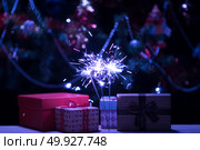 Christmas holding bengal burning sparkler light. Стоковое фото, агентство Ingram Publishing / Фотобанк Лори