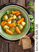 Vegetable soup with brussel sprouts on wooden rustic table, top view. Стоковое фото, агентство Ingram Publishing / Фотобанк Лори