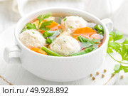 Fresh chicken soup with vegetables and meatballs in a bowl on white background. Top view. Стоковое фото, агентство Ingram Publishing / Фотобанк Лори