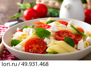 Pasta salad with fresh red cherry tomato and feta cheese. Italian cuisine. Стоковое фото, агентство Ingram Publishing / Фотобанк Лори