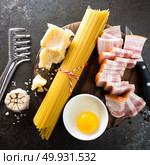 Ingredients for cooking Carbonara pasta, spaghetti with pancetta, egg and hard parmesan cheese. Traditional italian cuisine. Pasta alla carbonara. Стоковое фото, агентство Ingram Publishing / Фотобанк Лори
