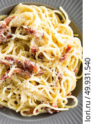 Carbonara pasta, spaghetti with pancetta, egg, hard parmesan cheese and cream sauce. Traditional italian cuisine. Pasta alla carbonara. Стоковое фото, агентство Ingram Publishing / Фотобанк Лори