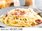 Carbonara pasta, spaghetti with pancetta, egg, hard parmesan cheese and cream sauce. Traditional italian cuisine. Pasta alla carbonara. Стоковое фото, агентство Ingram Publishing / Фотобанк Лори