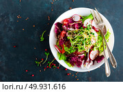 Fresh vegetable salad plate of tomatoes, italian mix, pepper, radish, green sprouts and flax seeds. Vegetarian dish, healthy food. Diet breakfast, lunch or dinner menu. Salad plate on table. Flat lay. View from above. Стоковое фото, агентство Ingram Publishing / Фотобанк Лори