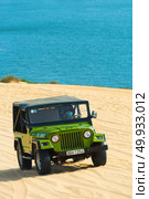 MUI NE - VIETNAM, JANUARY 18, 2016 : Tourists enjoy on the desert by jeep car in Mui ne, January 18, 2016. Редакционное фото, агентство Ingram Publishing / Фотобанк Лори
