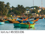 MUI NE, VIETNAM - FEBRUARY 08, 2016:i Fishing village and colorful fishing boats near Mui Ne at a sunny day. Редакционное фото, агентство Ingram Publishing / Фотобанк Лори