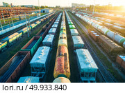 Cargo wagons. Aerial view of colorful freight trains. Railway station. Colorful wagons with goods on railroad. Heavy industry. Industrial landscape with train, railway platfform at sunset. Top view. Aerial view of colorful freight trains on railroad. Стоковое фото, агентство Ingram Publishing / Фотобанк Лори