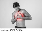 Young man has heart attack isolated on white background. Стоковое фото, агентство Ingram Publishing / Фотобанк Лори