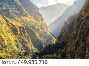 Colorful landscape with high Himalayan mountains, green forest, blue sky with clouds and yellow sunlight at sunrise in summer in Nepal. Mountain valley in the morning. Travel in Himalayas. Nature. Colorful landscape with mountains, river at sunrise in summer. Стоковое фото, агентство Ingram Publishing / Фотобанк Лори