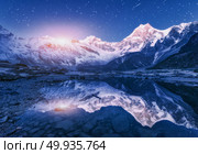 Night scene with himalayan mountains and mountain lake at starry night in Nepal. Landscape with high rocks with snowy peak and sky with stars and moon reflected in water. Moonrise Beautiful Manaslu. Himalayn mountains and mountain lake at starry night in Nepal. Стоковое фото, агентство Ingram Publishing / Фотобанк Лори