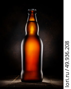 Lager beer in bottle on wooden background. Bar rack and beer. Стоковое фото, агентство Ingram Publishing / Фотобанк Лори