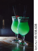 A beautiful green cocktail with white foam and cherry in a tall glass. close-up. Стоковое фото, агентство Ingram Publishing / Фотобанк Лори