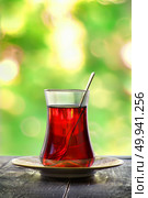 Glass of red turkish tea on a blurred background. Стоковое фото, агентство Ingram Publishing / Фотобанк Лори