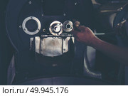 hand holding a probe of fresh roasted coffee beans in vintage filter image. Стоковое фото, агентство Ingram Publishing / Фотобанк Лори