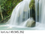 Deep forest waterfall at Erawan waterfall National Park Kanjanaburi Thailand. Стоковое фото, агентство Ingram Publishing / Фотобанк Лори