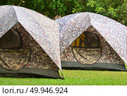 Campsite tent on filed for travel background. Стоковое фото, агентство Ingram Publishing / Фотобанк Лори