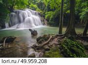 Deep forest waterfall at Erawan waterfall National Park Kanjanaburi Thailand. Стоковое фото, агентство Ingram Publishing / Фотобанк Лори