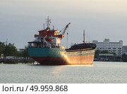 Cargo ship in the harbor at sunset, Thailand. Стоковое фото, агентство Ingram Publishing / Фотобанк Лори