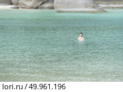 Phuket, THAILAND - JANUARY 4, 2017. A tourist wearing a bikini swim in the sea in Phuket. Редакционное фото, агентство Ingram Publishing / Фотобанк Лори
