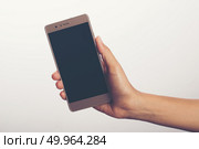 Close Up of a woman holding on mobile phone isolated on white ba. Close Up of a woman holding on mobile phone isolated on white background. Стоковое фото, агентство Ingram Publishing / Фотобанк Лори