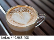 Close up of cappuccino cup with heart shaped milk pattern at caf. Close up of cappuccino cup with heart shaped milk pattern at cafe. a cup of coffee art. Стоковое фото, агентство Ingram Publishing / Фотобанк Лори