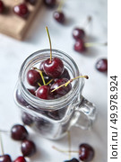 Freshly picked red cherries for cooking homemade sweet fruits tart on white table. Concept of healthy vegetarian food.. Natural fresh home grown fruits cherries of close-up. Ingredients for delicious berries pie on kitchen table. Стоковое фото, агентство Ingram Publishing / Фотобанк Лори