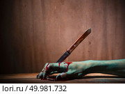Closeup, Ghost woman or zombie hold knife for kill with blood violence in house of ruin, nightmare, horror of scary fear on hell is monster devil in halloween festival. Стоковое фото, агентство Ingram Publishing / Фотобанк Лори