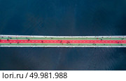 Aerial top view of pedestrian and cycling path lane on Park bridge and Dnieper river from above in city Kyiv , Ukraine. Drone photo. top view of pedestrian on Park bridge and Dnieper river in city Kiev , Ukraine. Стоковое фото, агентство Ingram Publishing / Фотобанк Лори
