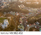 Beautiful aerial view at sunset on Vozdvizhenka district and the history museum of Podil. Kiev, Ukraine. Photo from the drone. Aerial view of Vozdvizhenka district and museum of Kiev history at sunset. Ukraine. Стоковое фото, агентство Ingram Publishing / Фотобанк Лори