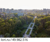Aerial photography from the drone, bird’s eye view to modern buildings of the Pechersk district and recreational area National Botanic Gardens in the city of Kiev at sunset in the summer.. A bird’s eye view, panoramic view from the drone to the view of the central alley of the Botanical Garden and the construction of the Pechersk district in the city of Kiev, Ukraine. Стоковое фото, агентство Ingram Publishing / Фотобанк Лори