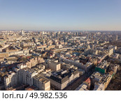 Beautiful cityscape of old and modern buildings, the roads of Kiev against the blue sky. Aerial photograph of the Olympic sports complex in the distance. City landscape of Kiev with modern and old houses roads with cars, Ukraine. Drone photography. Стоковое фото, агентство Ingram Publishing / Фотобанк Лори