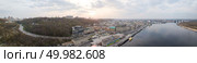 Aerial panoramic view from the drone to the district of Podil with the Postal square, Vladimirskaya gorka, Vladimir’s descent, hotels, river Port. Reflection of sunset and cloudy sky in the Dnieper River.. The full panoramic 360 aerial view from the drone, the bird’s eye view of the the oldest historical central part of the city of Kiev and the right bank of the Dnieper River, Ukraine. Стоковое фото, агентство Ingram Publishing / Фотобанк Лори