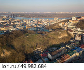 Aerial view from the drone, bird’s eye view to the oldest district Podol, the Vozdvizhenka, Podolsky bridge, St. Andrew’s Church, Andreevsky descent, Truhanov Island.. A bird’s eye view, aerial view from drone of the Podol district, oldest historical center of Kiev, Ukraine, the Dnieper River and the left bank of Dnieper. Стоковое фото, агентство Ingram Publishing / Фотобанк Лори