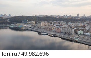 Panoramic view of the Podol district, the river station, the promenade and the river Dnipro, tourist ships and the church on the water Nickolas in the city Kyiv, Ukraine. Photo by drone. Panoramic view of Kiev historical district Podol with river Dnieper, Kiev, Ukraine. Стоковое фото, агентство Ingram Publishing / Фотобанк Лори