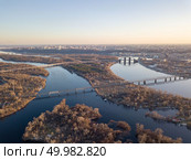 Panoramic view of the flood of the Dnieper River with the Petrovsky railway bridge and the North Bridge. Aerial photo of the right bank of Kiev, Ukraine. Panoramic view of the right bank of Kiev and the flood of the Dnieper river at sunset. Стоковое фото, агентство Ingram Publishing / Фотобанк Лори