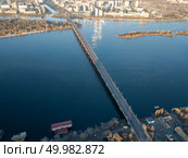 Amazing cityscape on the left bank of the Dnieper, modern construction and Patona bridge on a sunny summer day in Kiev, Ukraine. Aerial photography from flying drone. Aerial view from the drone to the Patona Bridge, Dnieper River in the city of Kiev, Ukraine. Стоковое фото, агентство Ingram Publishing / Фотобанк Лори