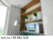 Natural lens bokeh.Blurred view of kitchen interior with shelves, vases and microwave near the window. Blurred view of kitchen interior with shelves. Стоковое фото, агентство Ingram Publishing / Фотобанк Лори