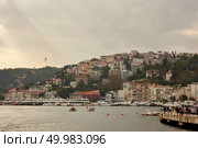 Istanbul, Turkey - December 11, 2017: Beautiful panoramic view of Istanbul from the sea to the coastal line with boats, ancient buildings, streets with people. Istanbul, Turkey - December 11, 2017: Beautiful panoramic view of Ferries in the Bosphorus, Редакционное фото, агентство Ingram Publishing / Фотобанк Лори