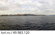 View of the old historical building with mosques, towers, buildings in the eastern style, Bosphorus Bridge on the background of cloudy sky.. Landscape panoramic view from the sea to the historical part of Istanbul, Turkey. Стоковое фото, агентство Ingram Publishing / Фотобанк Лори