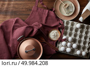 Kitchen utensils and ingredients for making a pie on an old wooden table with an apron.. Ingredients for pie. Стоковое фото, агентство Ingram Publishing / Фотобанк Лори