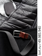 black belt on a winter jacket. Clothing background. black belt on a winter jacket. Стоковое фото, агентство Ingram Publishing / Фотобанк Лори