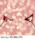Two glasses with cocktail for martini with splash on a pink background bokeh. Two glasses with cocktail. Стоковое фото, агентство Ingram Publishing / Фотобанк Лори